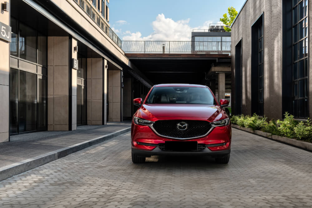 What Makes Mazda CX SUVs Different Front view of new Mazda CX-5 in business downtown